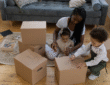 Image showing family decluttering with storage boxes (Image Credit: Familius)
