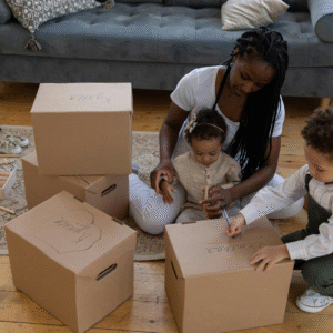Image showing family decluttering with storage boxes (Image Credit: Familius)