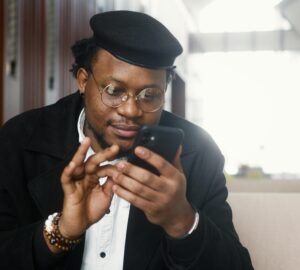 Man in Black Suit Jacket Holding Black Smartphone (Image Credit: Artem Podrez on Pexels)
