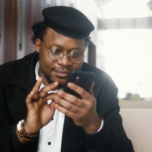 Man in Black Suit Jacket Holding Black Smartphone (Image Credit: Artem Podrez on Pexels)