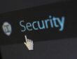 Image shows the mouse click hand pointing on a text with the word security
